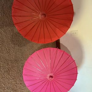 Pair of Chinese style paper umbrellas red and pink